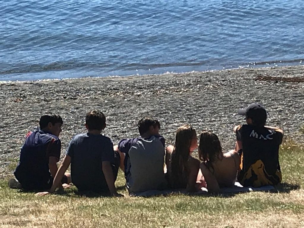 Kids sitting on a beach