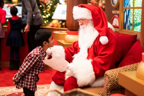 Santa with smiling child.